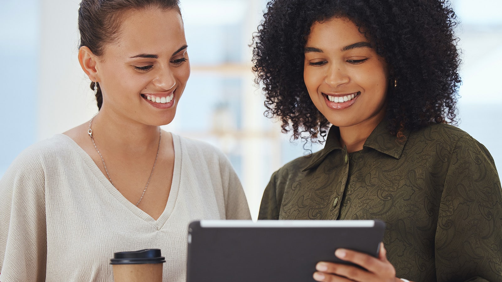 Digital Planning African american women smiling as they look at tablet