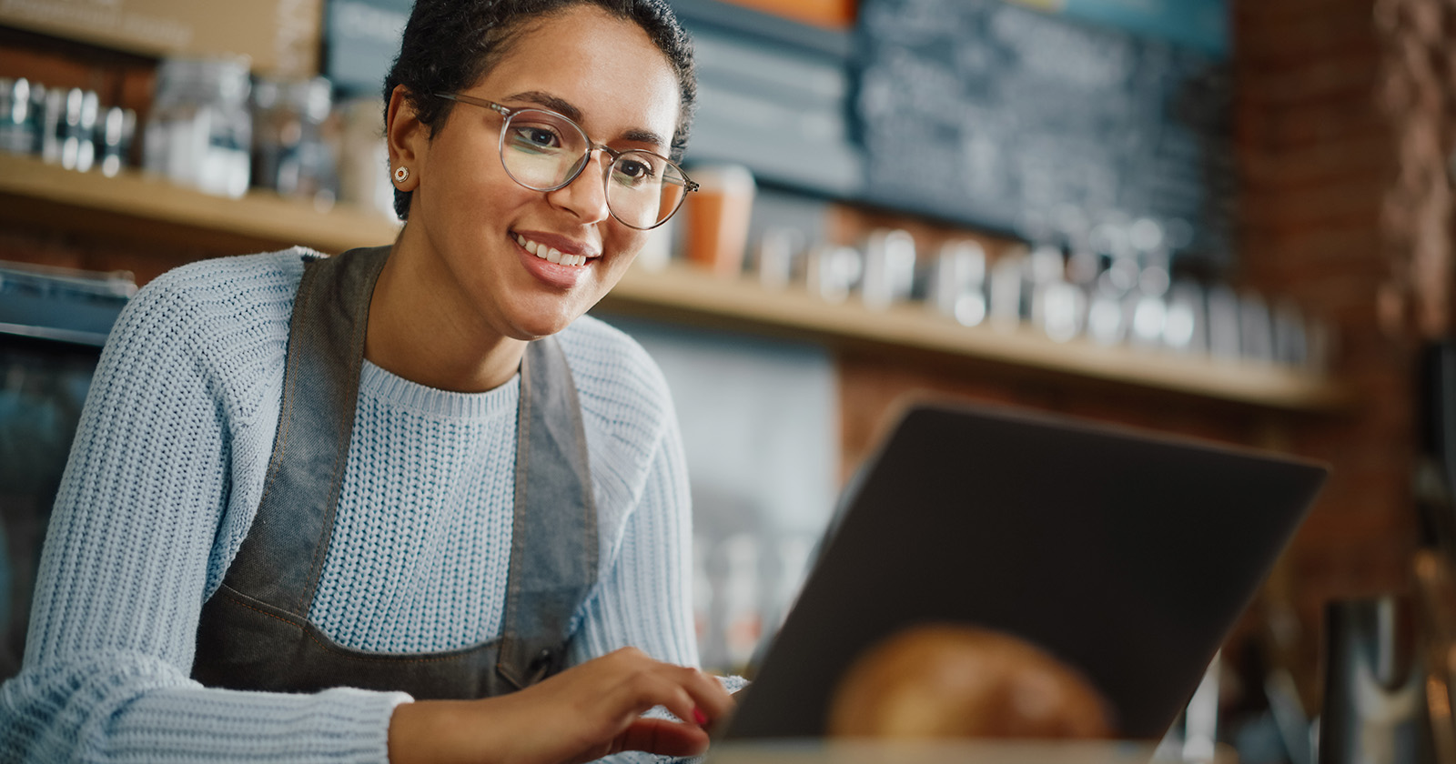 Pointclickcare users Woman wearing glasses using a laptop