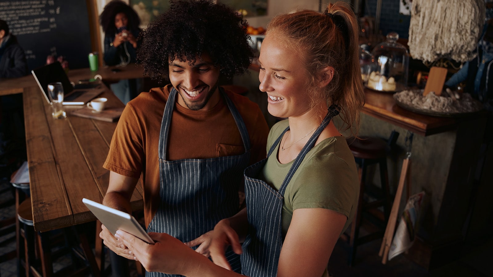 Adopting technological change High angle view of young cafe owners